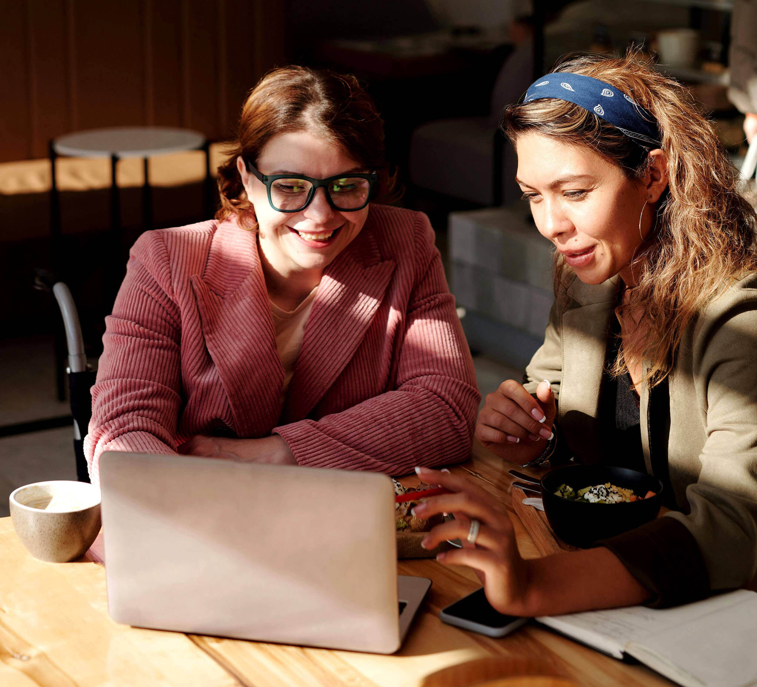 Two women having a discussion at a small table